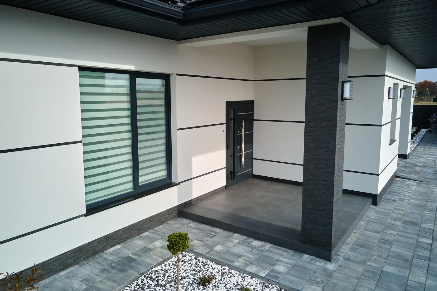 Smooth white stucco exterior with a covered entry
