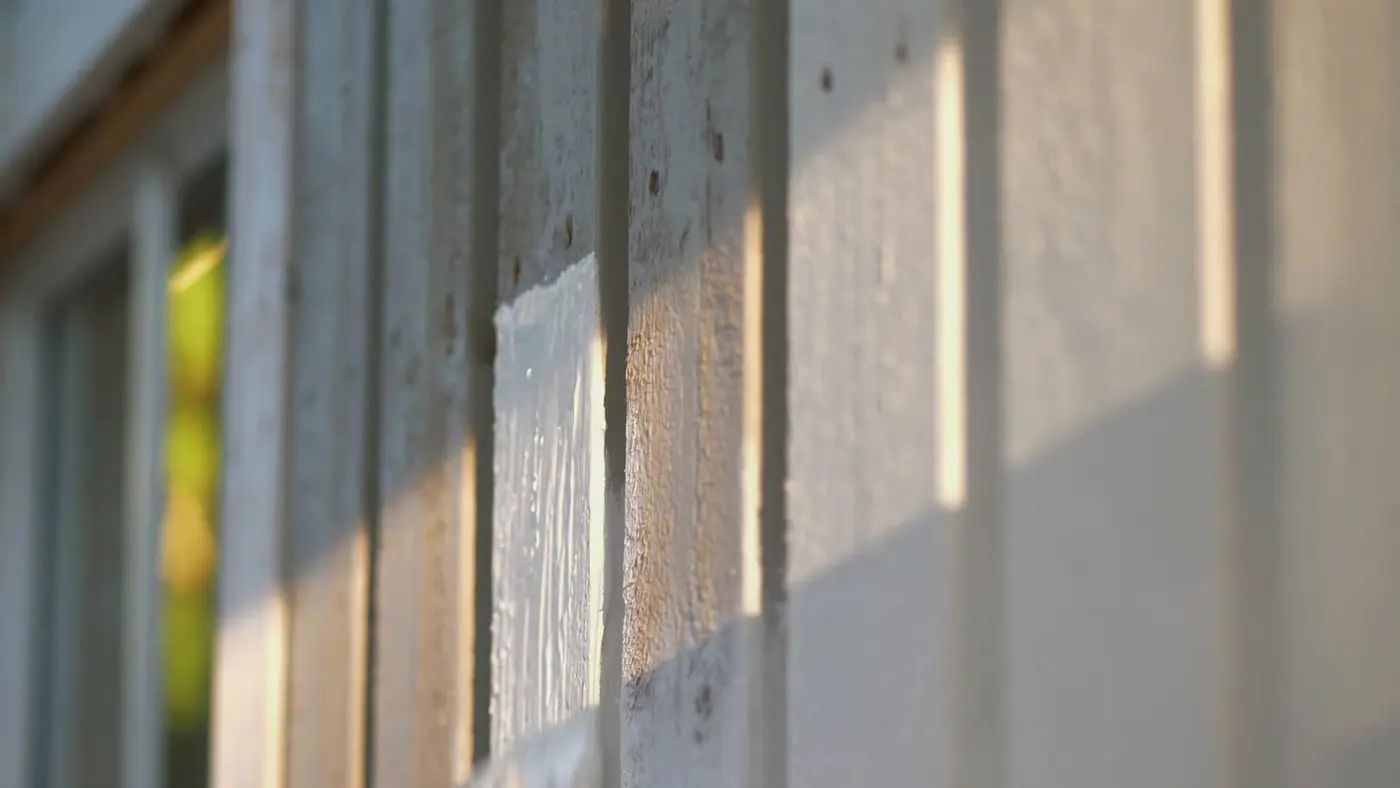 Textured wall lit by low side light, showing surface depth