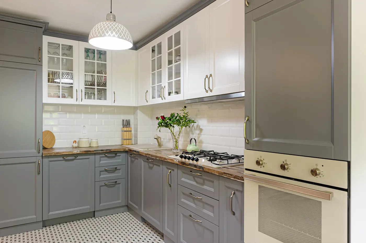 Kitchen with gray lower cabinets and white upper cabinets after painting