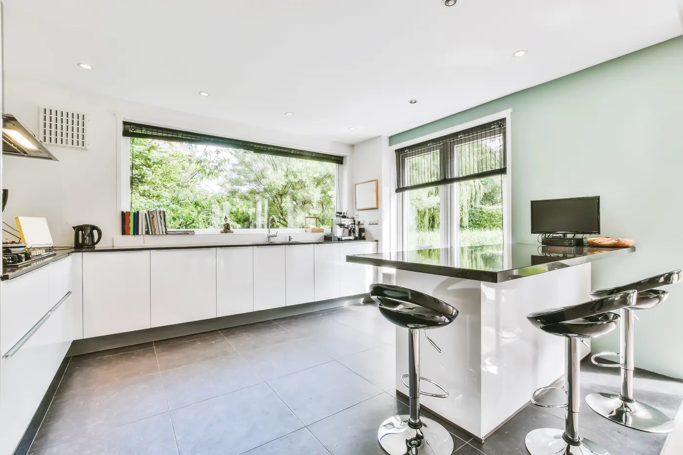 Bright kitchen with white painted walls and a sage accent